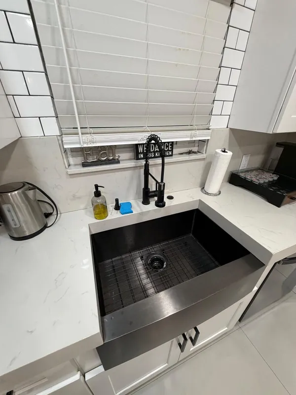 The same kitchen sink empty and clean after the turnover