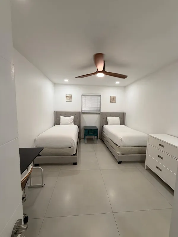 The same bedroom with both twin beds made after the turnover